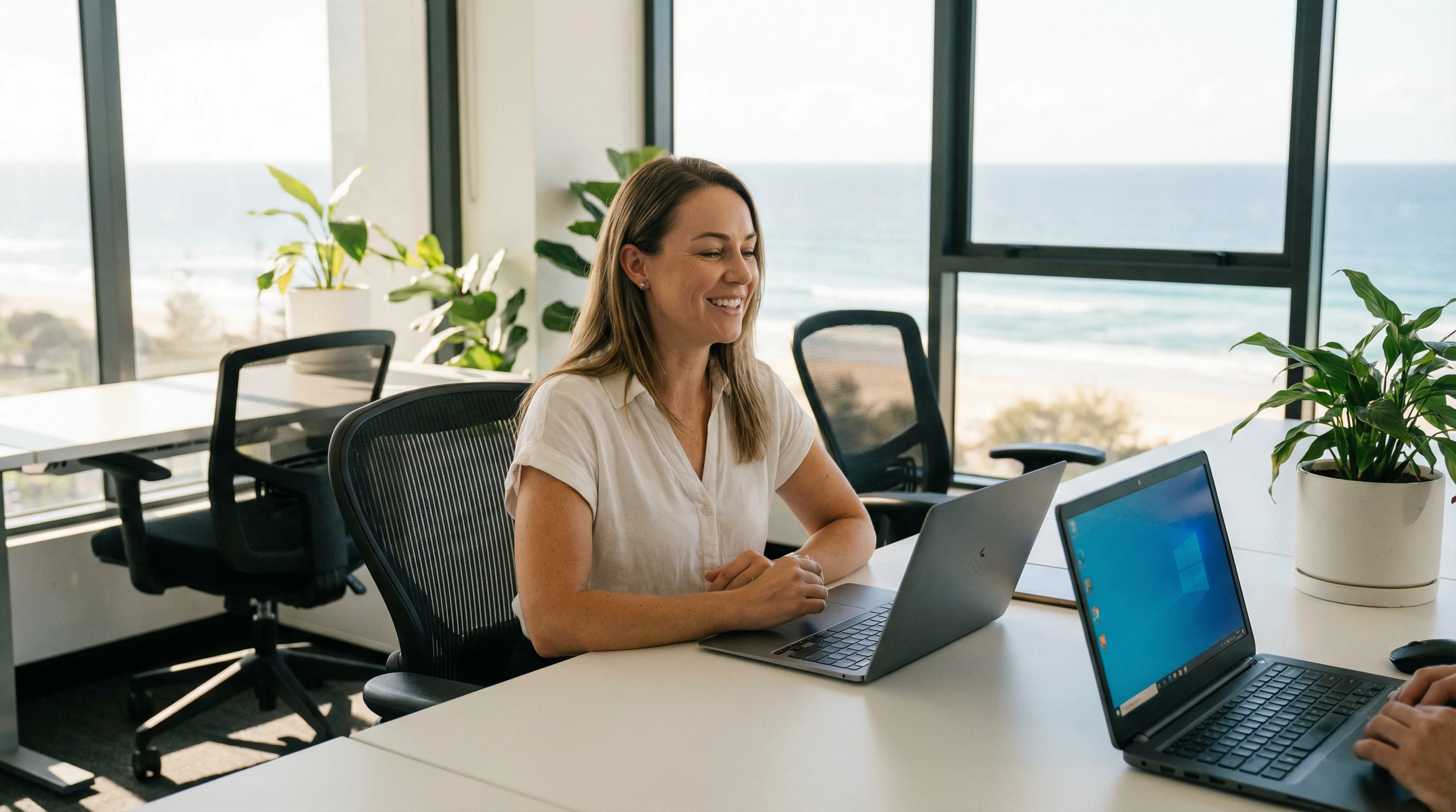 Gold Coast business office manager with Windows and Mac laptops for hardware software troubleshooting